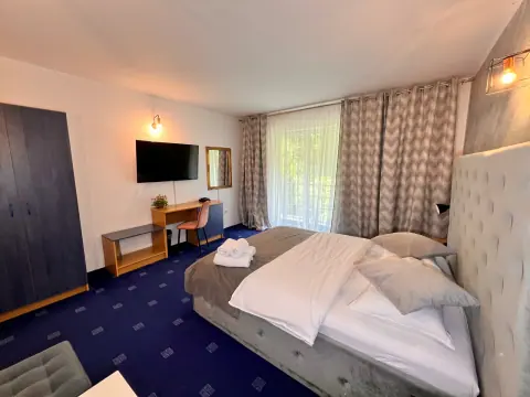 Double bedroom with a television and bright balcony
