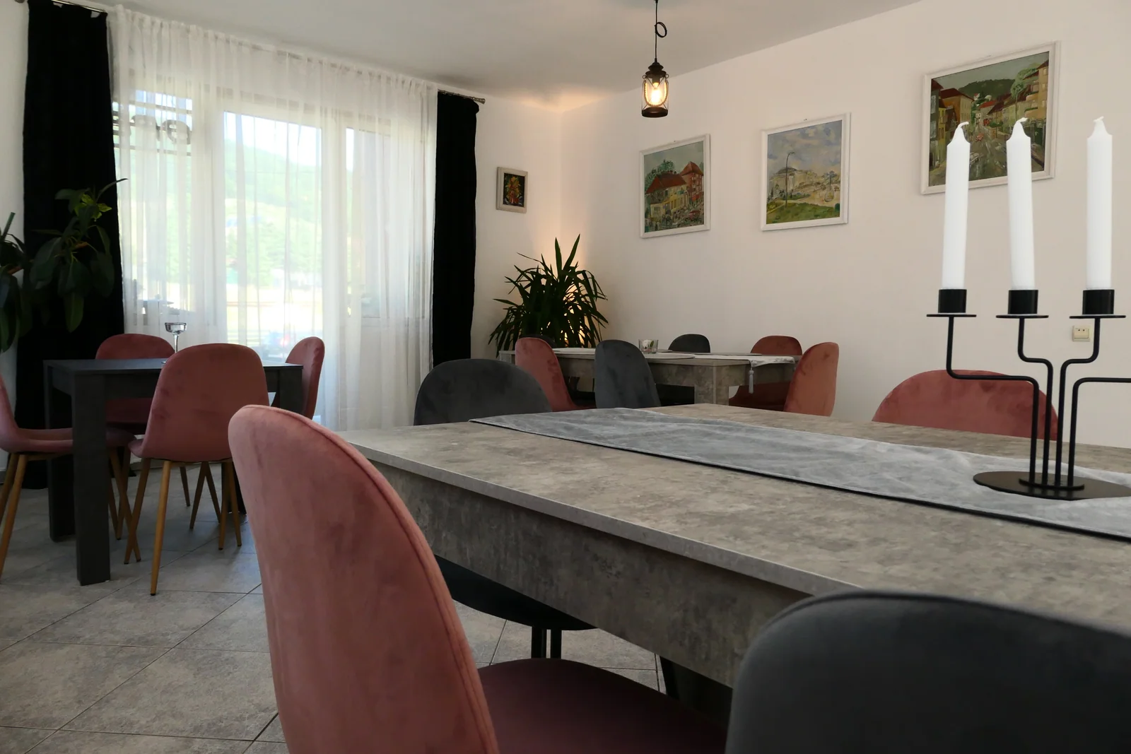 Sala de mese cu scaune și ferestre spre grădină
